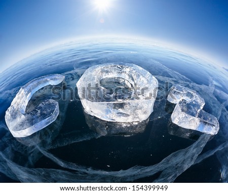Chemical formula of greenhouse gas carbon dioxide CO2 made from ice on winter frozen lake Baikal under blue sky and Sun rays