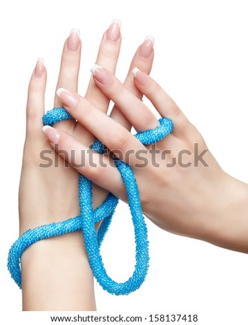 isolated close-up shot of young woman\'s beautiful hands with beads