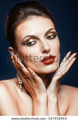 Beautiful young woman with vogue shining face makeup