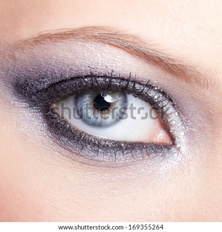 Eye of young woman with vogue shining sparkle makeup