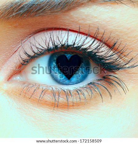 Closeup shot of woman eye with heart in the pupil