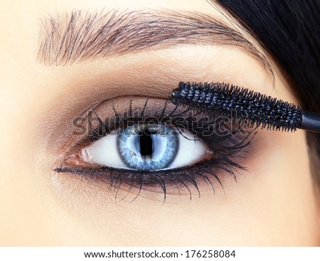 Close-Up Shot Of Woman Face And Makeup Brush Applying Mascara Make-Up On Eye Lashes