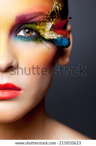 Young pretty woman face with false feather eyelashes fashion makeup