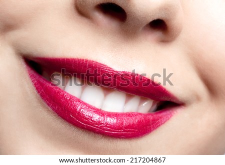 close-up shot of beautiful woman\'s smiling lips classic bright red make up