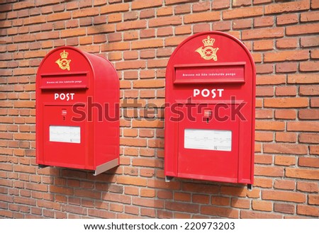COPENHAGEN, DENMARK - AUGUST 22, 2014: Mail boxes on brick wall. Red old style mail boxes a common in Copenhagen and Denmark