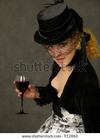 Portrait of  attractive lady with glass of wine. Dressed in Polish amazon clothes and silk hat with veil