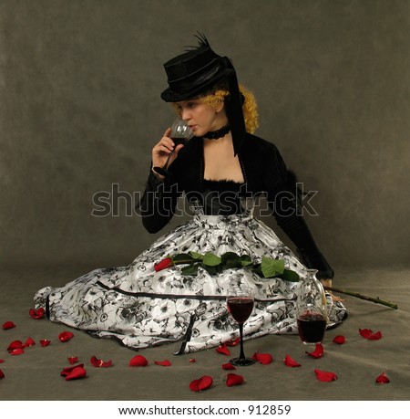 Portrait of attractive lady drinking wine. Dressed in Polish amazon clothes and silk hat with veil