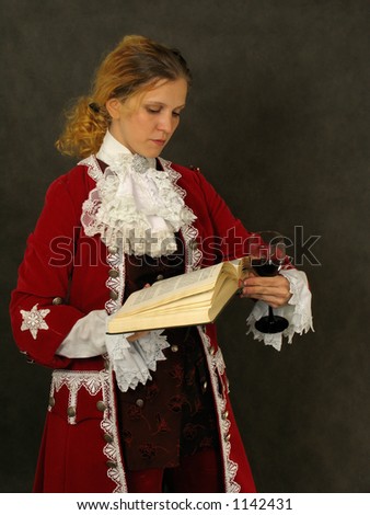 Woman dressed in french clothes of 18 century reading a book