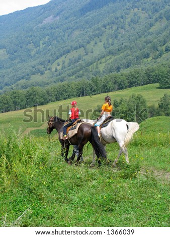 Young girls traveling in Altay mountains on horses