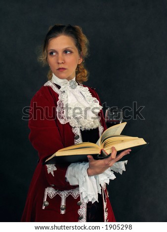 Woman dressed in french clothes of 18 century with a book