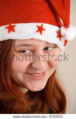 Portrait of red-haired girl in the Christmas cap