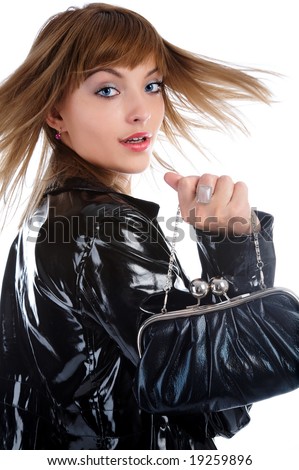 attractive young model in bright black raincoat turns back and her hair flutter