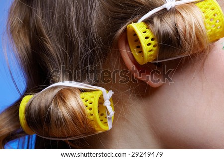close up of girl\'s hair with yellow hair rollers