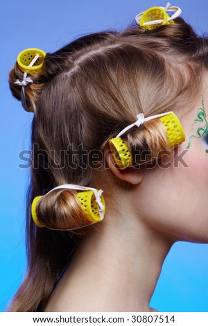 close up of girl\'s hair with yellow hair rollers