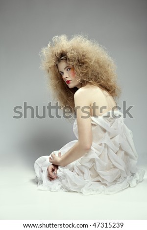 portrait of caucasian girl with girl with shock hair-do sitting on floor