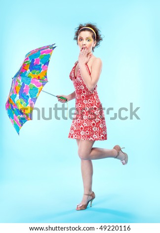 portrait of beautiful slavonic girl posing with big colorful umbrella
