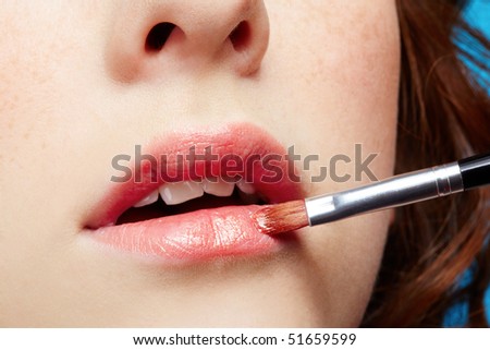 close-up of freckled girl\'s lips zone make up