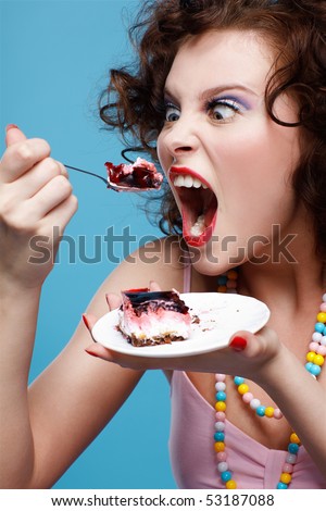 stock photo portrait of beautiful curly brunette girl eating cake