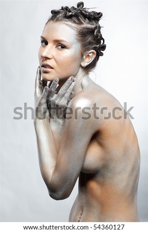 stock photo portrait of nude girl body painted with silver posing on gray
