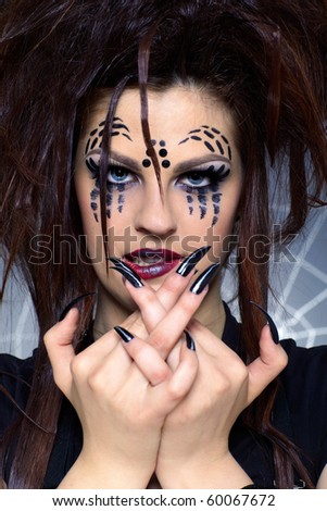 close up portrait of girl with spider bodyart of face zone and black finger-nails