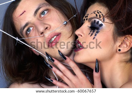 portrait of girl with spider bodyart of face zone and her boy victim