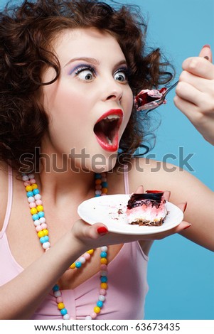 stock photo portrait of beautiful curly brunette girl eating cake