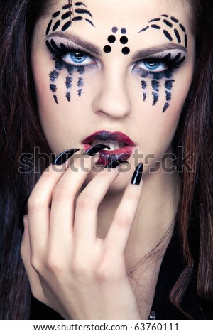 close up portrait of girl with spider bodyart of face zone and black finger-nails