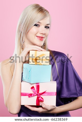 portrait of beautiful blonde party girl with birthday gift box on pink