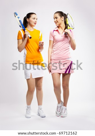 stock photo portrait of two sporty girls tennis players with rackets