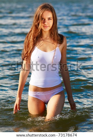 stock photo Young beautiful slavonic girl in white wet top and panties 