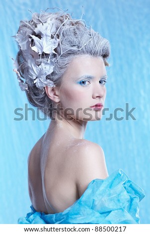 fantasy portrait of beautiful young woman imaging ice fairy on frozen blue