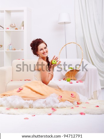 full-length portrait of young beautiful retro woman in vintage skirt with petticoat posing in vintage falt with rose petals around