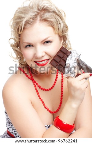 isolated portrait of beautiful happy young blonde size plus woman model with bar of chocolate in foil
