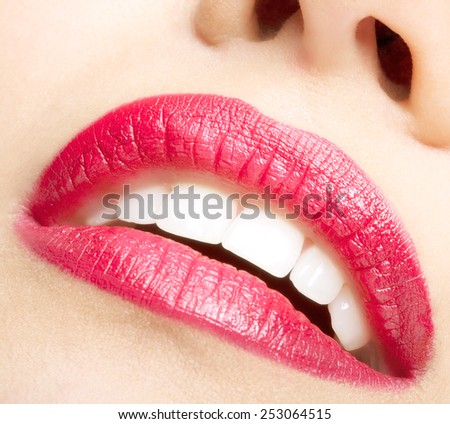 Smiling female red lips and healthy white teeth closeup shot with mouth open