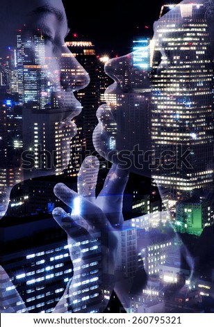 Young couple of lovers kissing on night lights Tokyo background