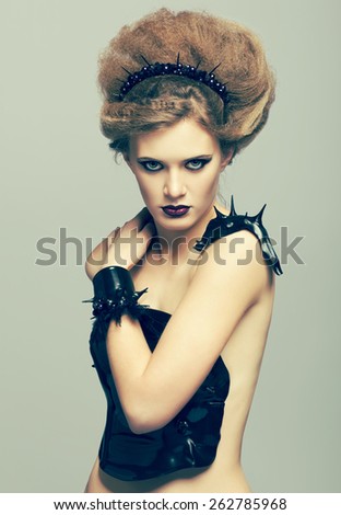 Woman in dress and diadem made of molten vinyl disk