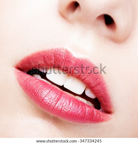 Close up shot of red female lips, teeth and nose