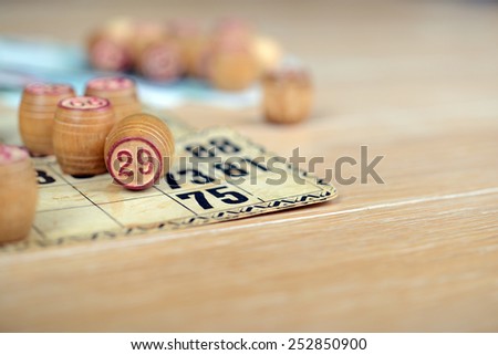 bingo (lotto) kegs and cards with rubles on the wooden table. Retro, vintage.