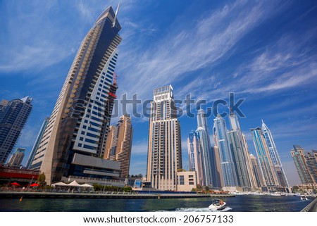 Dubai Marina with boat against skyscrapers in Dubai, United Arab Emirates