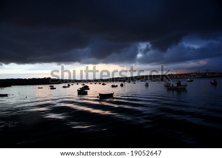 Dramatic atmosphere with boats before big storm