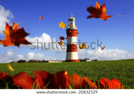 beautiful lighthouse with flying autumn  leaves
