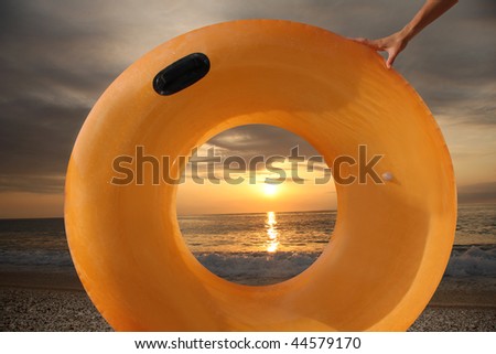 swimming belt against sunset on the beach