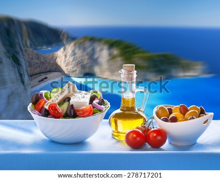 Famous Navagio beach with Greek salad in Zakynthos, Greece