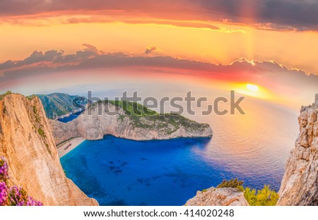 Navagio beach with shipwreck and flowers against sunset on Zakynthos island in Greece