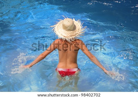 Woman in the swimming pool during summer season
