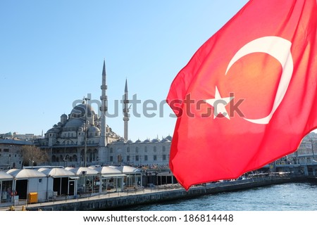 Reversed turkish flag on cruise boat with a view of the Yeni Cami