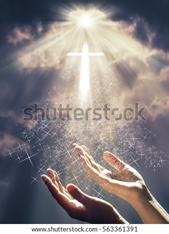 Hands reach out toward a radiant shining cross in supplication prayer for salvation