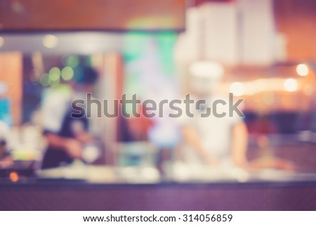 Vintage tone of Abstract blur of Pizza or italian restaurant with chef in the background