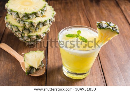 pineapple juice and pineapple smoothie on wood table. for health