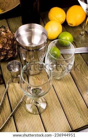 Bartender preparation before party fime, fruits, shaker, cutting board and glasses
